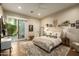 Cozy bedroom with a light color palette, plush rug, decorative shelving, and a sliding glass door to the backyard at 6455 E Calle Del Media --, Scottsdale, AZ 85251