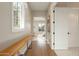 Bright hallway with hardwood floors, a wooden bench, and natural light streaming through the window at 6455 E Calle Del Media --, Scottsdale, AZ 85251