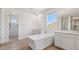 Bright bathroom with free standing tub, double vanity, and shower at 7436 W Buckhorn Trl, Peoria, AZ 85383