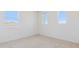 Bright bedroom with carpeted flooring, white walls, and natural light at 7436 W Buckhorn Trl, Peoria, AZ 85383