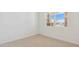 A bright, carpeted bedroom features neutral walls, bright natural light, and a window at 7436 W Buckhorn Trl, Peoria, AZ 85383