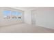 Bright bedroom with three large windows, carpeted flooring, and white walls at 7436 W Buckhorn Trl, Peoria, AZ 85383