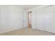 Well-lit bedroom features clean white walls, carpet, closet, and bright white doors at 7436 W Buckhorn Trl, Peoria, AZ 85383