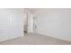 Bedroom with closet and ensuite bathroom entrances, carpet, and white walls at 7436 W Buckhorn Trl, Peoria, AZ 85383