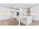 Bright kitchen with large island, stainless vent hood, and built in microwave and oven at 7436 W Buckhorn Trl, Peoria, AZ 85383