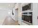 Bright kitchen with stainless appliances, built in microwave and oven, with wood floors at 7436 W Buckhorn Trl, Peoria, AZ 85383
