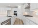 Bright kitchen with large island, stainless appliances, and stone backsplash at 7436 W Buckhorn Trl, Peoria, AZ 85383