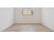 Bright room with light wood floors, neutral walls, and a window at 7436 W Buckhorn Trl, Peoria, AZ 85383