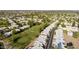 Aerial view of golf course community with a lake, a fountain, the community pool, and tennis courts at 755 S Arrowwood Way, Mesa, AZ 85208