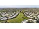 Aerial of a green golf course winding through a neighborhood with well-manicured lawns and desert landscaping at 755 S Arrowwood Way, Mesa, AZ 85208