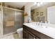 Bathroom featuring dark wood vanity, tile flooring, and glass shower at 755 S Arrowwood Way, Mesa, AZ 85208