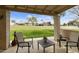 View from the covered patio overlooking a large green lawn, creating a peaceful and inviting outdoor space at 755 S Arrowwood Way, Mesa, AZ 85208