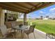 Enjoy the covered patio with a view of well-maintained greenery and a tranquil setting at 755 S Arrowwood Way, Mesa, AZ 85208