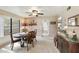 Inviting dining area with a wood table and views into the kitchen, perfect for Gathering meals and entertaining at 755 S Arrowwood Way, Mesa, AZ 85208