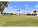 Scenic golf course view with lush green grass, walking path, and well-maintained landscaping at 755 S Arrowwood Way, Mesa, AZ 85208