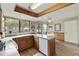 Bright kitchen with laminate countertops, wood cabinets, a large window, and an adjacent breakfast nook at 755 S Arrowwood Way, Mesa, AZ 85208