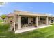 Enjoy outdoor living on this covered patio with seating area, perfect for relaxing or entertaining at 755 S Arrowwood Way, Mesa, AZ 85208