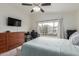 Sunlit bedroom featuring a modern wooden dresser, a workspace by the window, and comfortable sleeping arrangements at 927 E Baylor Ln, Gilbert, AZ 85296