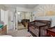 Bedroom featuring two cribs, and sunshine themed decorations on the walls at 927 E Baylor Ln, Gilbert, AZ 85296