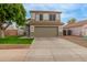 Two-story home with a large garage and well-maintained lawn at 927 E Baylor Ln, Gilbert, AZ 85296