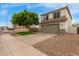 Two-story home featuring a green lawn, mature tree, and two-car garage at 927 E Baylor Ln, Gilbert, AZ 85296