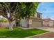 Charming two-story house with green lawn, wide driveway, and mature tree at 927 E Baylor Ln, Gilbert, AZ 85296