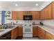 Functional kitchen features standard appliances and wood cabinetry at 927 E Baylor Ln, Gilbert, AZ 85296