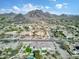 Expansive aerial view of a home and neighborhood, showcasing mountain views and mature landscaping at 9826 N 131St St, Scottsdale, AZ 85259