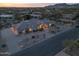 Beautiful aerial view of a desert property featuring lush landscaping, a winding driveway, and an illuminated facade at 9826 N 131St St, Scottsdale, AZ 85259