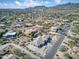 Beautiful aerial view of a home in an upscale neighborhood, showcasing mountain views and desert landscaping at 9826 N 131St St, Scottsdale, AZ 85259