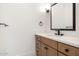 Well-lit powder room with a modern vanity, stylish fixtures, and a sleek mirror at 9826 N 131St St, Scottsdale, AZ 85259