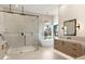 Modern bathroom featuring a glass shower, soaking tub, and double vanity at 9826 N 131St St, Scottsdale, AZ 85259