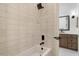 Bathroom with a bathtub featuring a shower head and light colored tiled wall at 9826 N 131St St, Scottsdale, AZ 85259