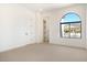 Bright bedroom with a large arched window offering picturesque mountain views and natural light at 9826 N 131St St, Scottsdale, AZ 85259