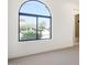 Bright bedroom featuring a large arched window with beautiful views and modern finishes at 9826 N 131St St, Scottsdale, AZ 85259