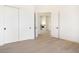 Bright bedroom with light wood floors, white trim and doors, and a view to the living area and fireplace at 9826 N 131St St, Scottsdale, AZ 85259