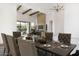 Bright dining room with wood beams overlooks the living area with modern fireplace and backyard pool at 9826 N 131St St, Scottsdale, AZ 85259