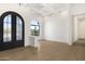 Bright foyer featuring arched double doors, wood floors, coffered ceiling, and a view from the arched window at 9826 N 131St St, Scottsdale, AZ 85259