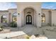 Inviting front entrance featuring a arched doorway and manicured desert landscaping at 9826 N 131St St, Scottsdale, AZ 85259