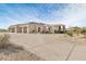 Wide view of the house, showing a spacious multiple-car garage and desert landscaping at 9826 N 131St St, Scottsdale, AZ 85259