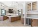 Kitchen with stainless steel appliances, wine refrigerator, cooktop, and marble countertop island at 9826 N 131St St, Scottsdale, AZ 85259