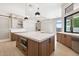 Kitchen with marble countertop island, open shelving, stainless steel appliances, and cooktop at 9826 N 131St St, Scottsdale, AZ 85259