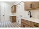 Well-equipped laundry room with custom cabinets, quartz countertops, stylish flooring, and modern fixtures at 9826 N 131St St, Scottsdale, AZ 85259