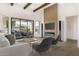 Bright living room features high ceilings with wood beams and a modern fireplace with tile accent wall at 9826 N 131St St, Scottsdale, AZ 85259