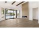 Elegant living room features a modern fireplace, hardwood floors, and large sliding doors to the backyard pool at 9826 N 131St St, Scottsdale, AZ 85259