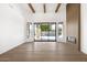 Bright living room with hardwood floors, fireplace, wood beam ceiling and sliding doors to the backyard pool at 9826 N 131St St, Scottsdale, AZ 85259