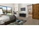 Serene main bedroom features a fireplace, tv, access to en-suite bathroom with barn door at 9826 N 131St St, Scottsdale, AZ 85259