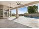 Covered patio with stone floors and ceiling fans overlooking the stunning pool area at 9826 N 131St St, Scottsdale, AZ 85259