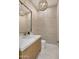 Elegant powder room with decorative lighting, textured wallpaper and tiled floors at 9826 N 131St St, Scottsdale, AZ 85259