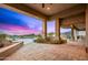 Outdoor patio with desert landscaping overlooking a sparkling swimming pool and mountain views at 10325 E Celestial Dr, Scottsdale, AZ 85262